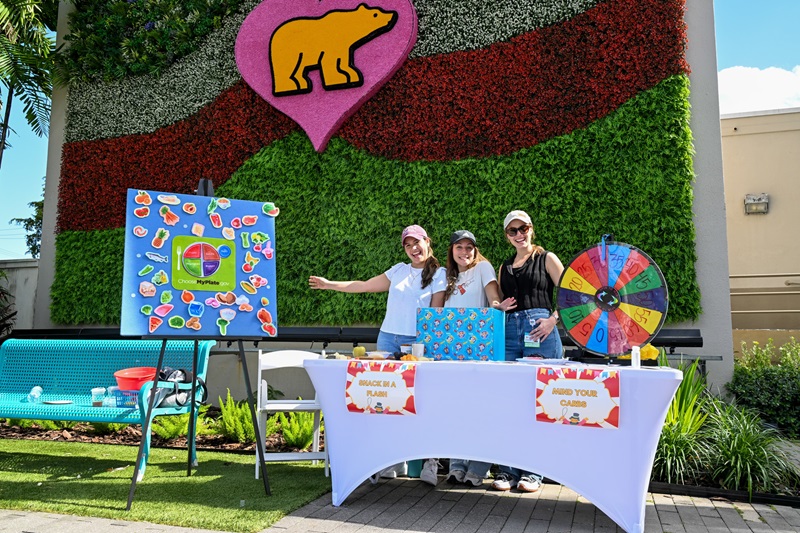 Three females standing at booth during the Diabetes Carnival.