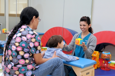 Vanessa Bello, Speech Therapist, and two-year-old Mason Maercks, during a rehabilitation session at MCH Midtown Outpatient Center.