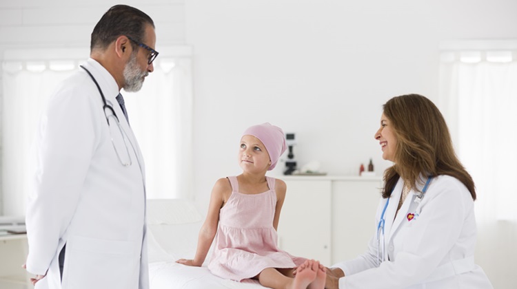 Male and female doctor meeting with young female cancer patient.
