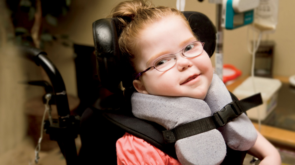 girl in neck brace and special wheelchair.