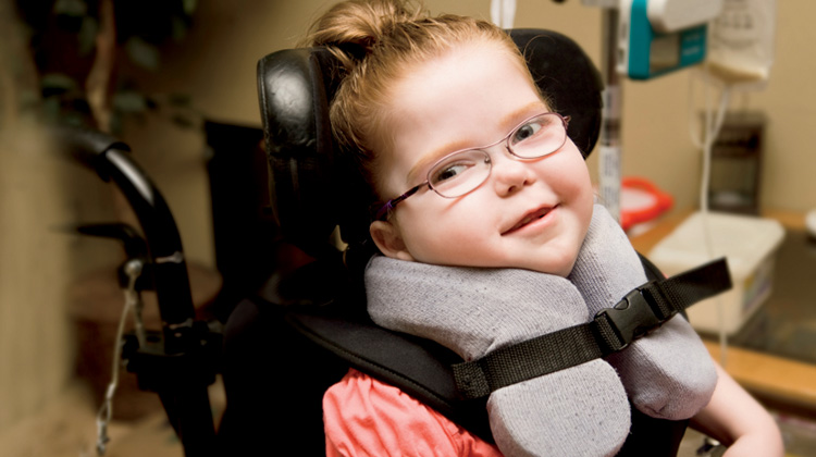 girl in neck brace and special wheelchair.