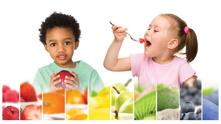 boy holding apple and girl eating with a fork, rainbow of fruits and vegetables.