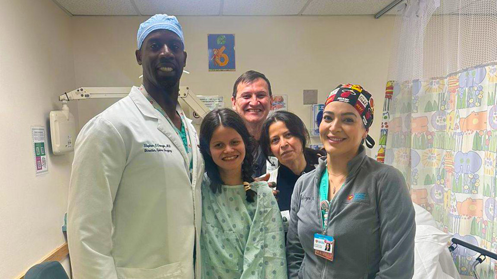 mikaela with her parents and medical team.