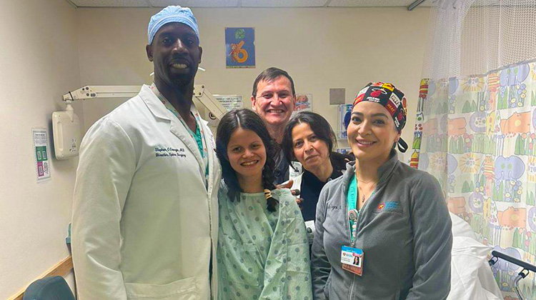 mikaela with her parents and medical team.