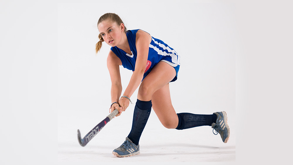 young girl playing lacrosse.