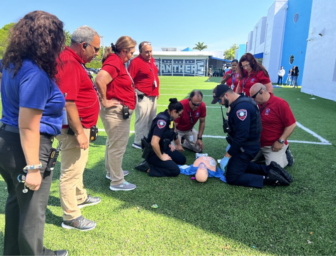 staff demonstrates use of AED on mannequin.