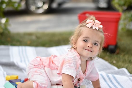 Francesca on a picnic blanket crawling